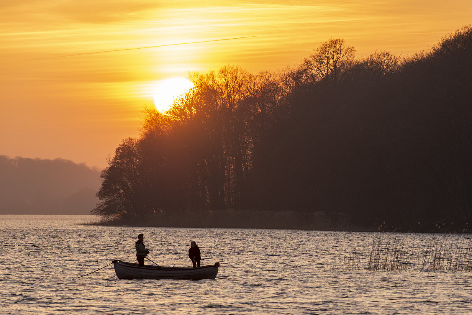 Lystfiskere i solnedgangen